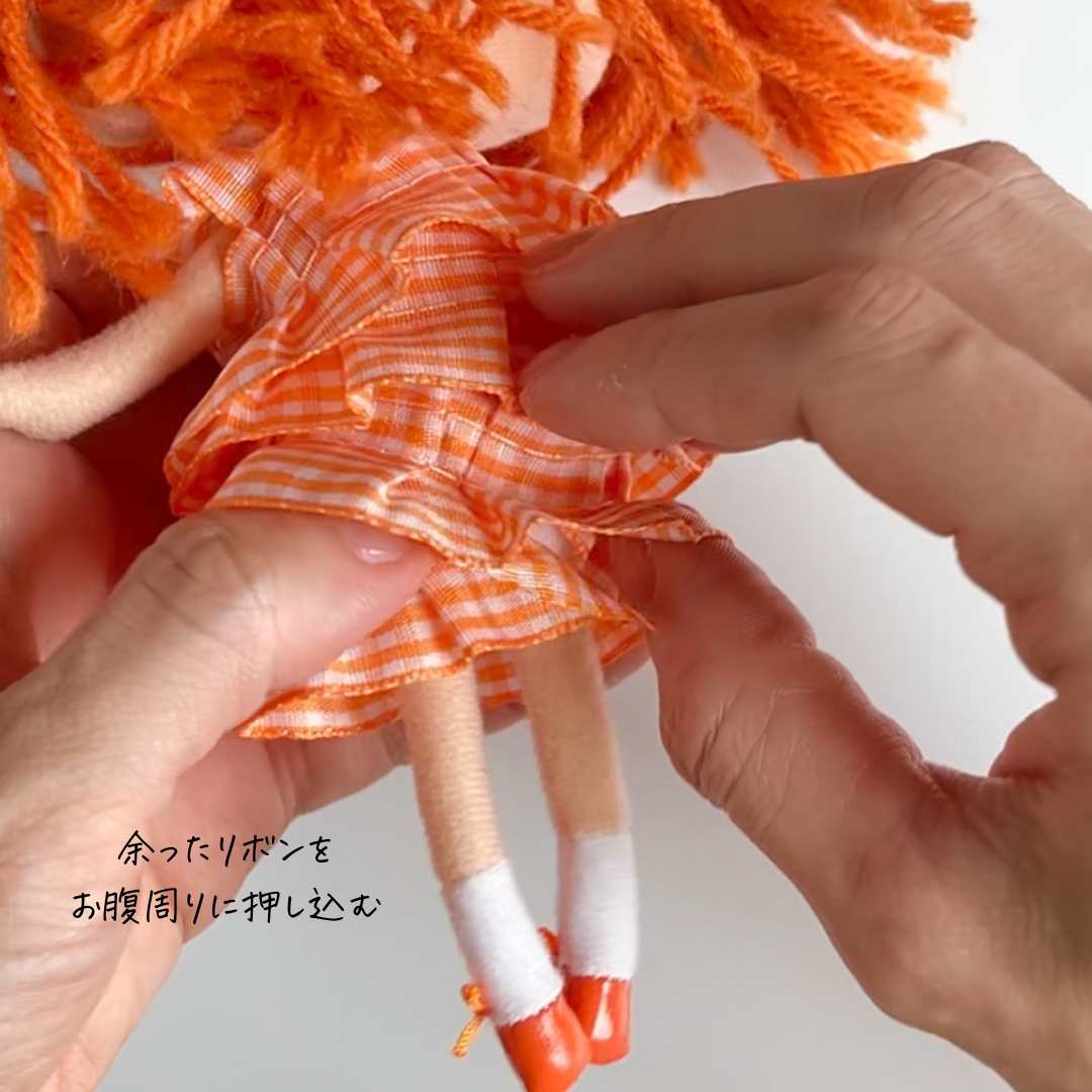 余ったリボンをお腹周りに押し込む